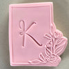 Elegant rectangle floral frame cookie stamp with pink fondant displayed on a cookie