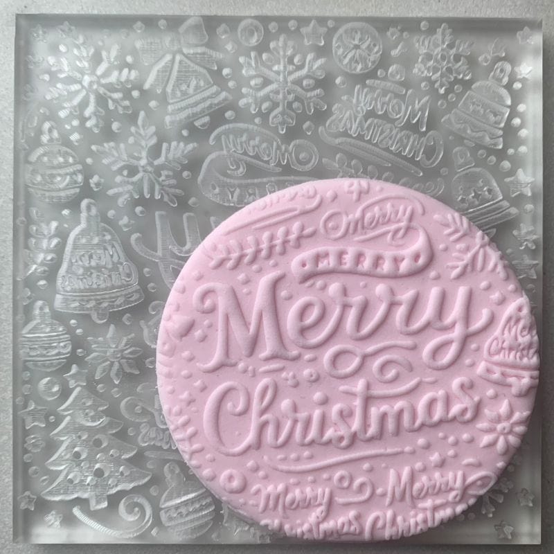 Festive Merry Christmas embosser stamp with detailed typography and holiday designs on fondant