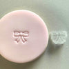 Mini Bow Cookie Stamp used to create decorated fondant cookie