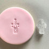Mini Champagne Cookie Stamp used to create decorated fondant cookie
