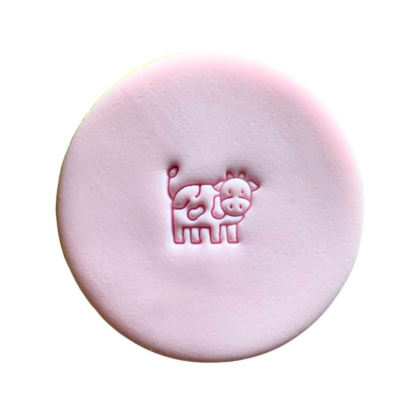 Mini Cow Cookie Stamp creating cute cow design on fondant.